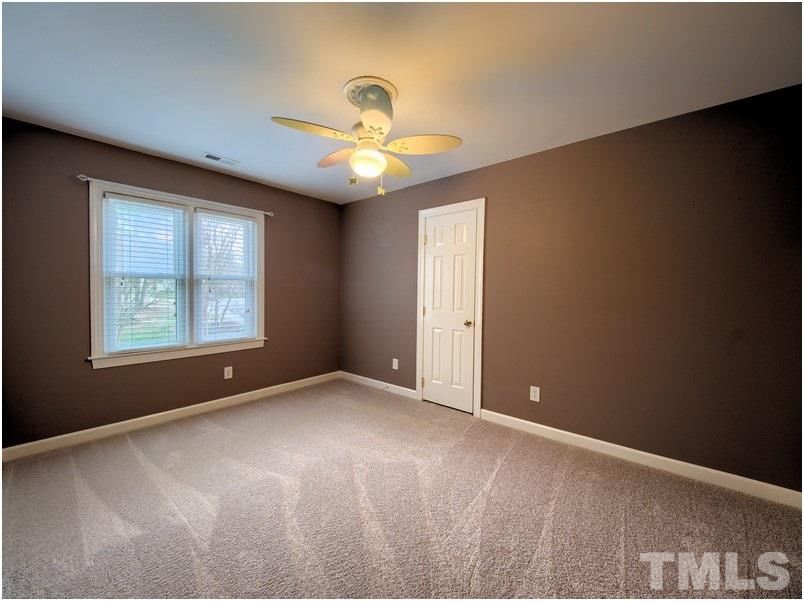 2521 Village Grove Road Raleigh, NC 27613 - Photo 18 of 25 an empty room with windows and fan