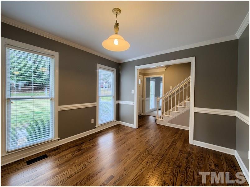 2521 Village Grove Road Raleigh, NC 27613 - Photo 3 of 25 a view of an empty room with wooden floor and a window