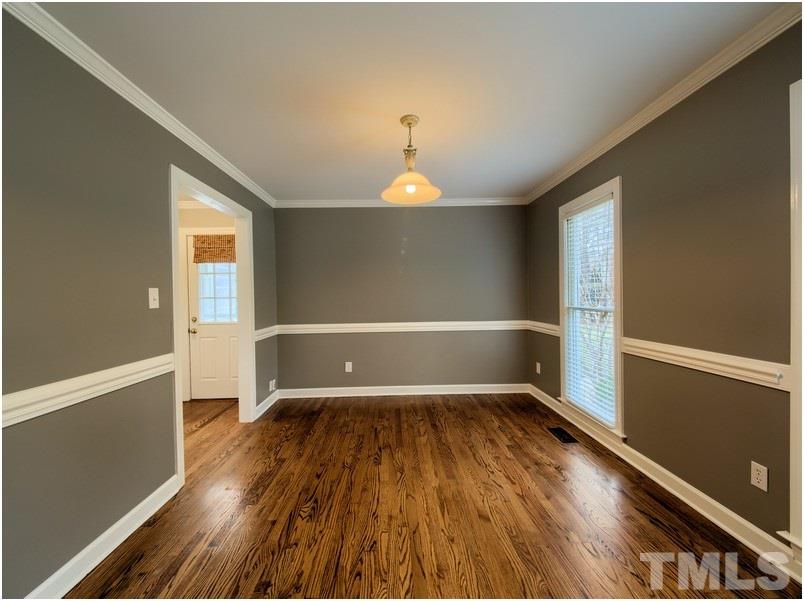 2521 Village Grove Road Raleigh, NC 27613 - Photo 4 of 25 wooden floor in an empty room with a window