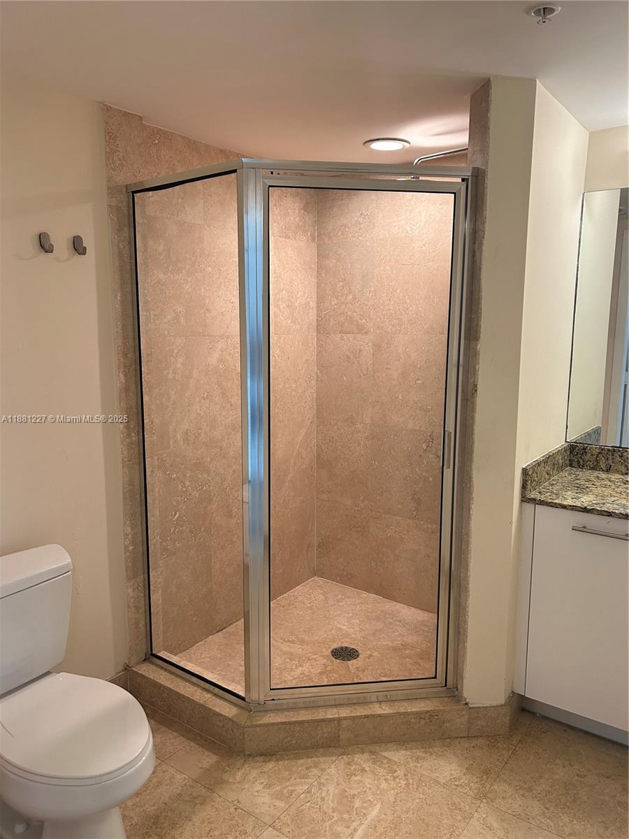 41 Southeast 5th Street, Unit 1108 Miami, FL 33131 - Photo 3 of 8 a bathroom with a shower a toilet and a sink