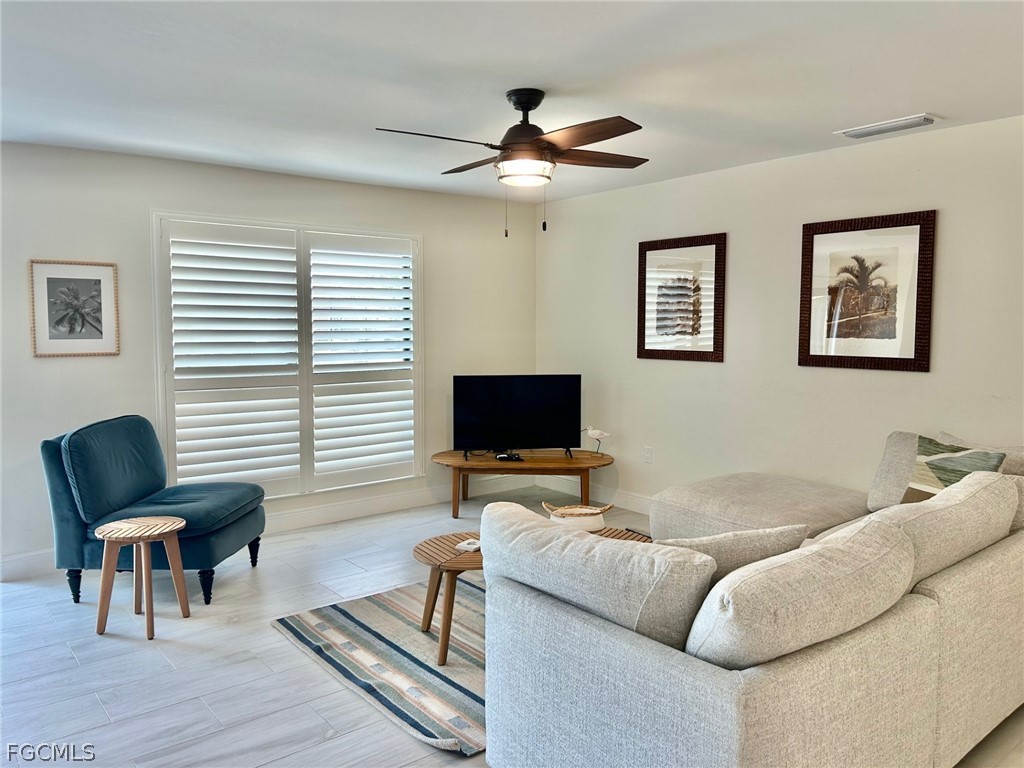 5117 Sea Bell Road, Unit E104 Sanibel, FL 33957 - Photo 8 of 31 a living room with furniture and a flat screen tv