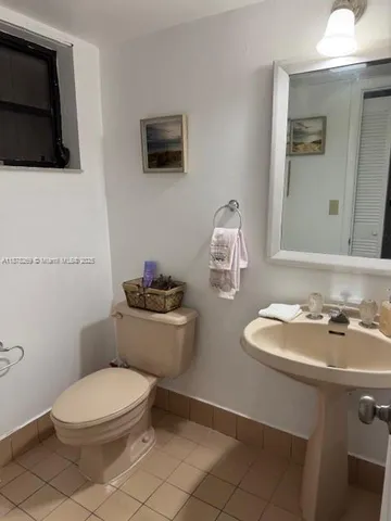 a bathroom with a toilet a sink and a mirror