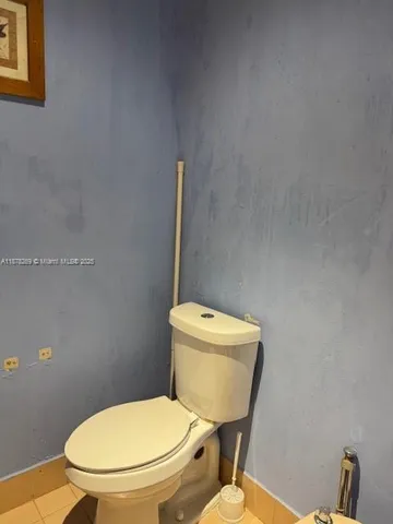 a white toilet sitting next to a toilet