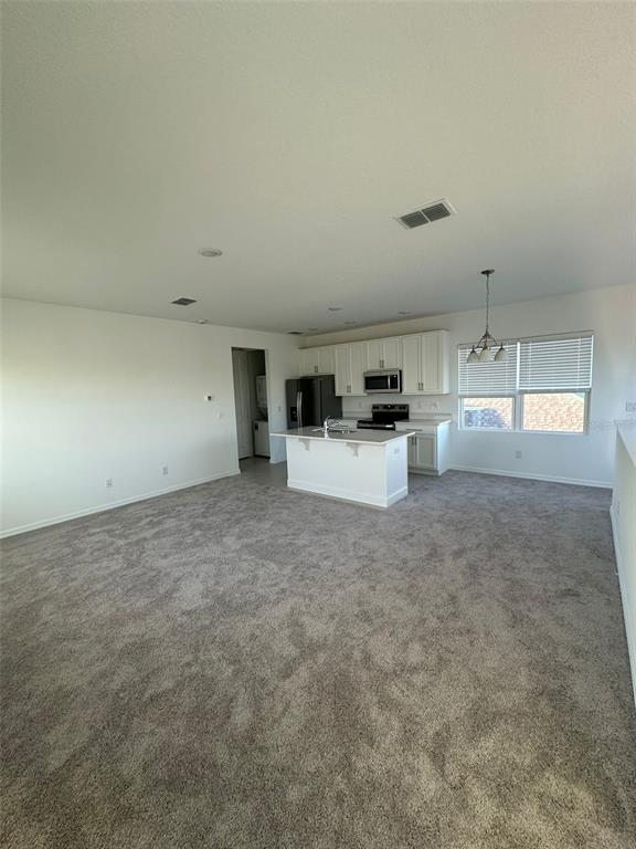 6718 Sherpa Trail, Unit A St. Cloud, FL 34771 - Photo 2 of 13 a view of a kitchen with microwave and cabinets