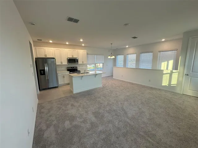 a view of kitchen and refrigerator