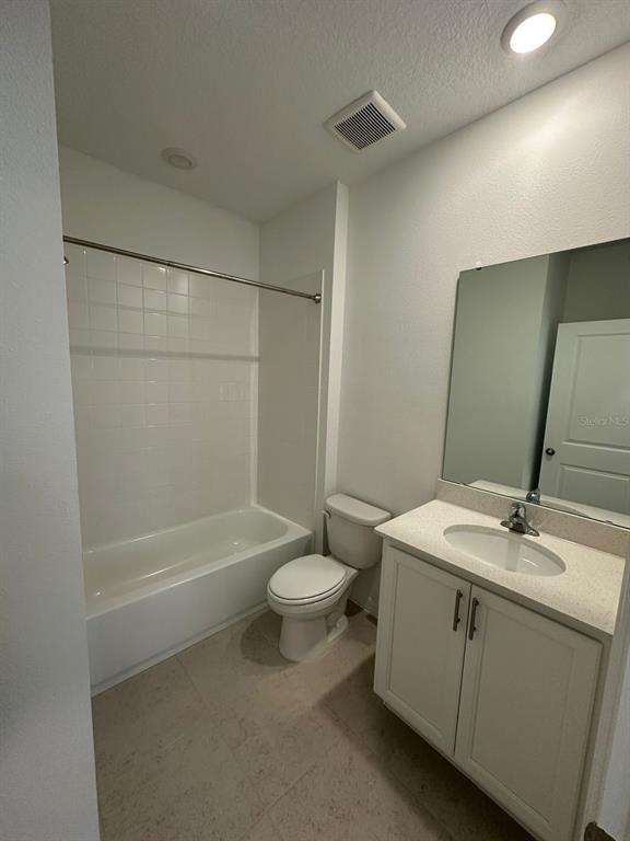 6718 Sherpa Trail, Unit A St. Cloud, FL 34771 - Photo 7 of 13 a bathroom with a sink a toilet and shower