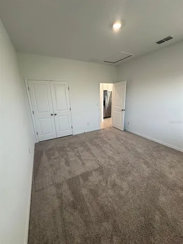 a view of an empty room and a window