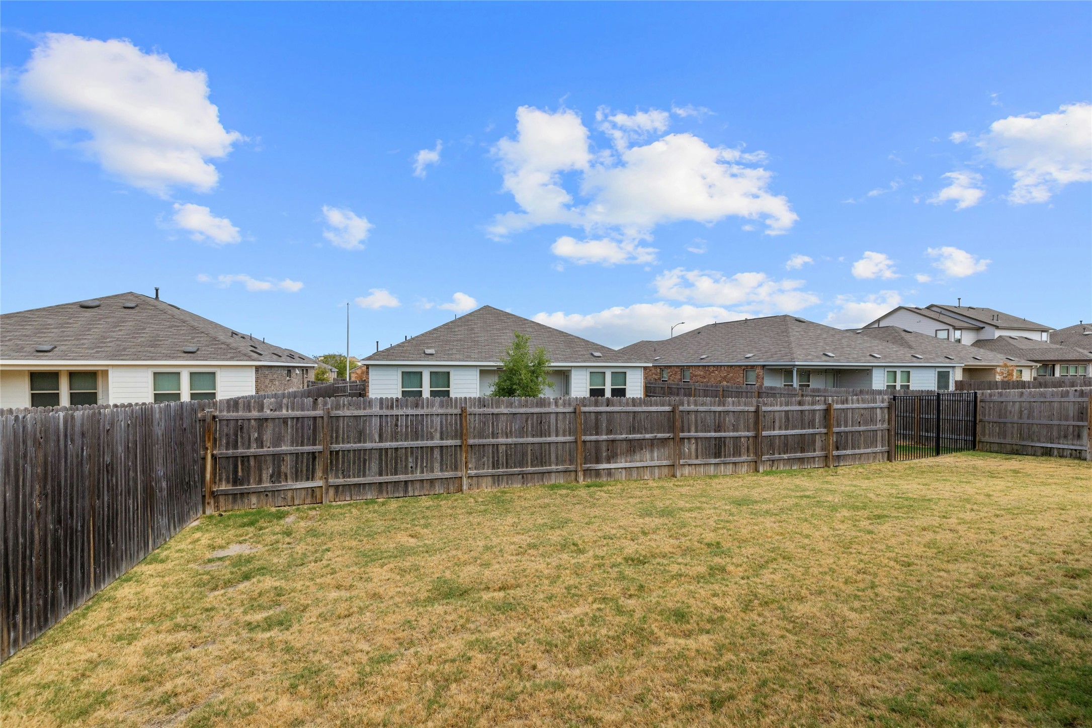 11813 Roscommon Trail Austin, TX 78754 - Photo 28 of 28 a view of a house with swimming pool and a yard