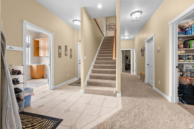 708 Eagle Rdg Drive Bountiful, UT 84010 - Photo 21 of 69 2nd level staircase and access from lower garage level