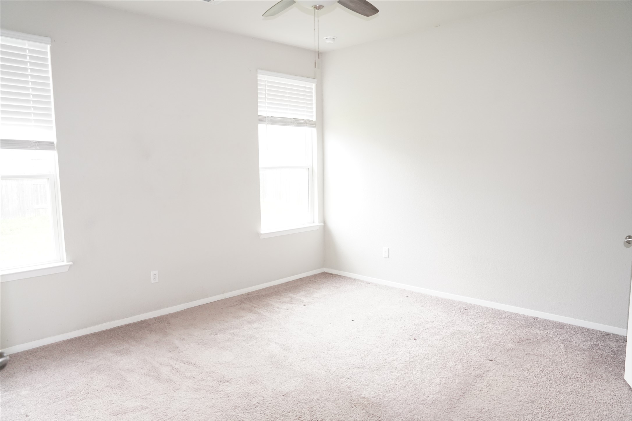 117 Crescent Street Georgetown, TX 78626 - Photo 14 of 38 A well-lit bedroom with fresh carpet and large windows awaits your personal touch.