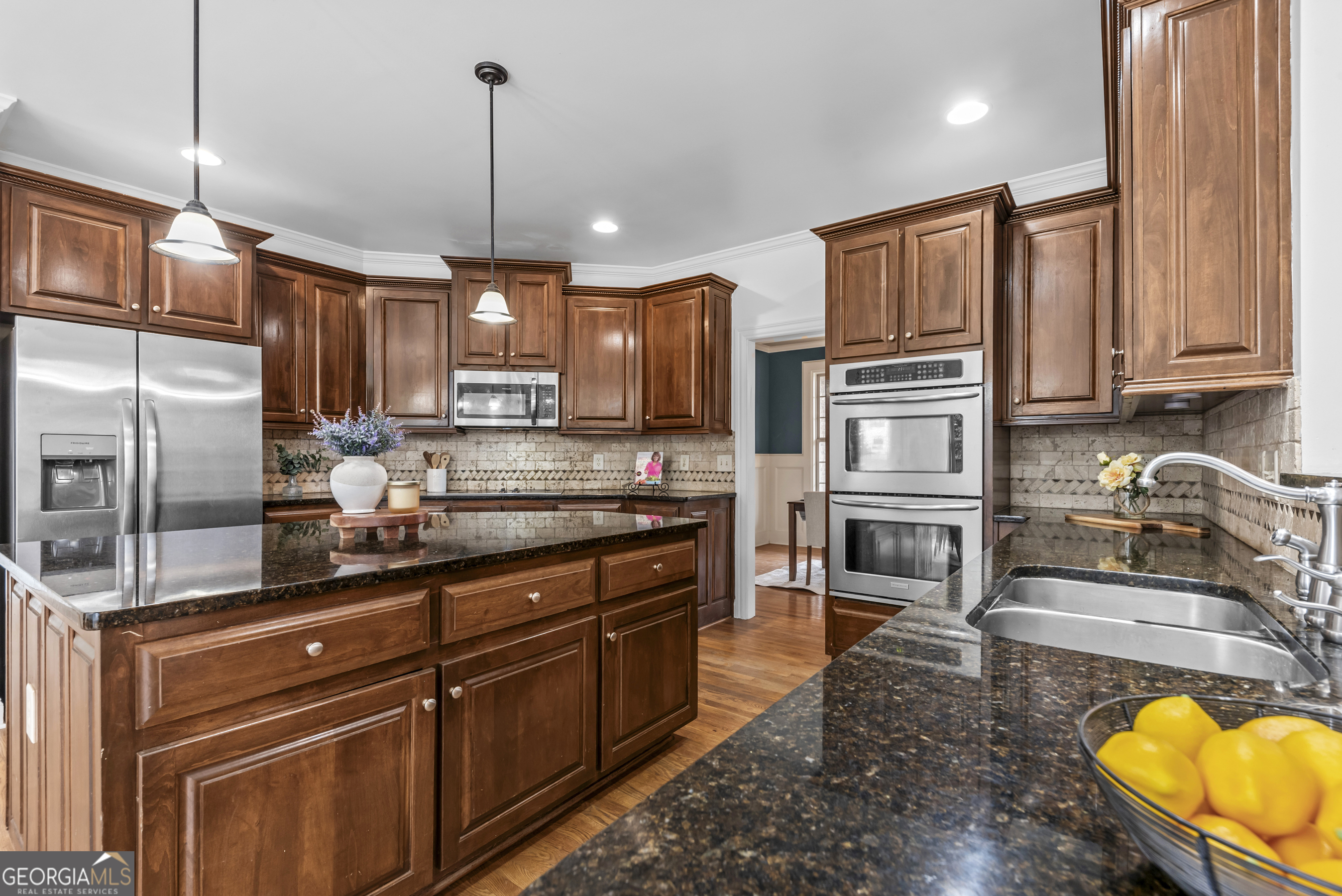 463 Delaperriere Loop Jefferson, GA 30549 - Photo 13 of 75 a kitchen with stainless steel appliances granite countertop a sink refrigerator and cabinets