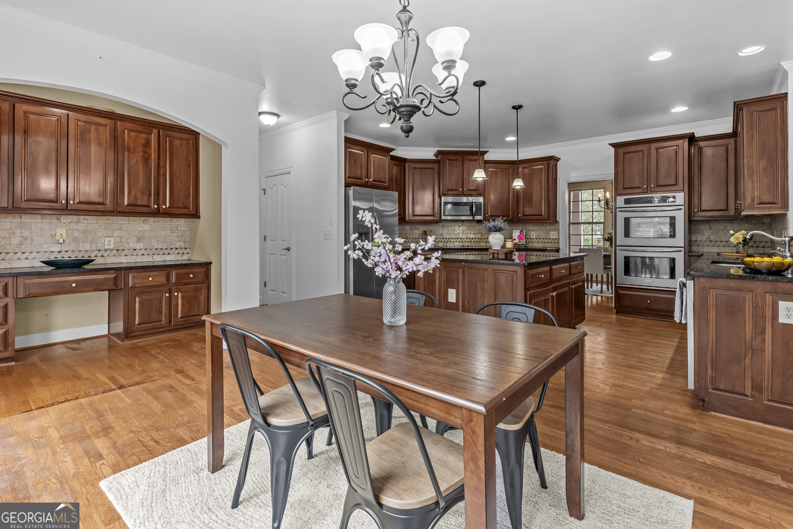 463 Delaperriere Loop Jefferson, GA 30549 - Photo 15 of 75 a view of a dining room with furniture a chandelier and wooden floor