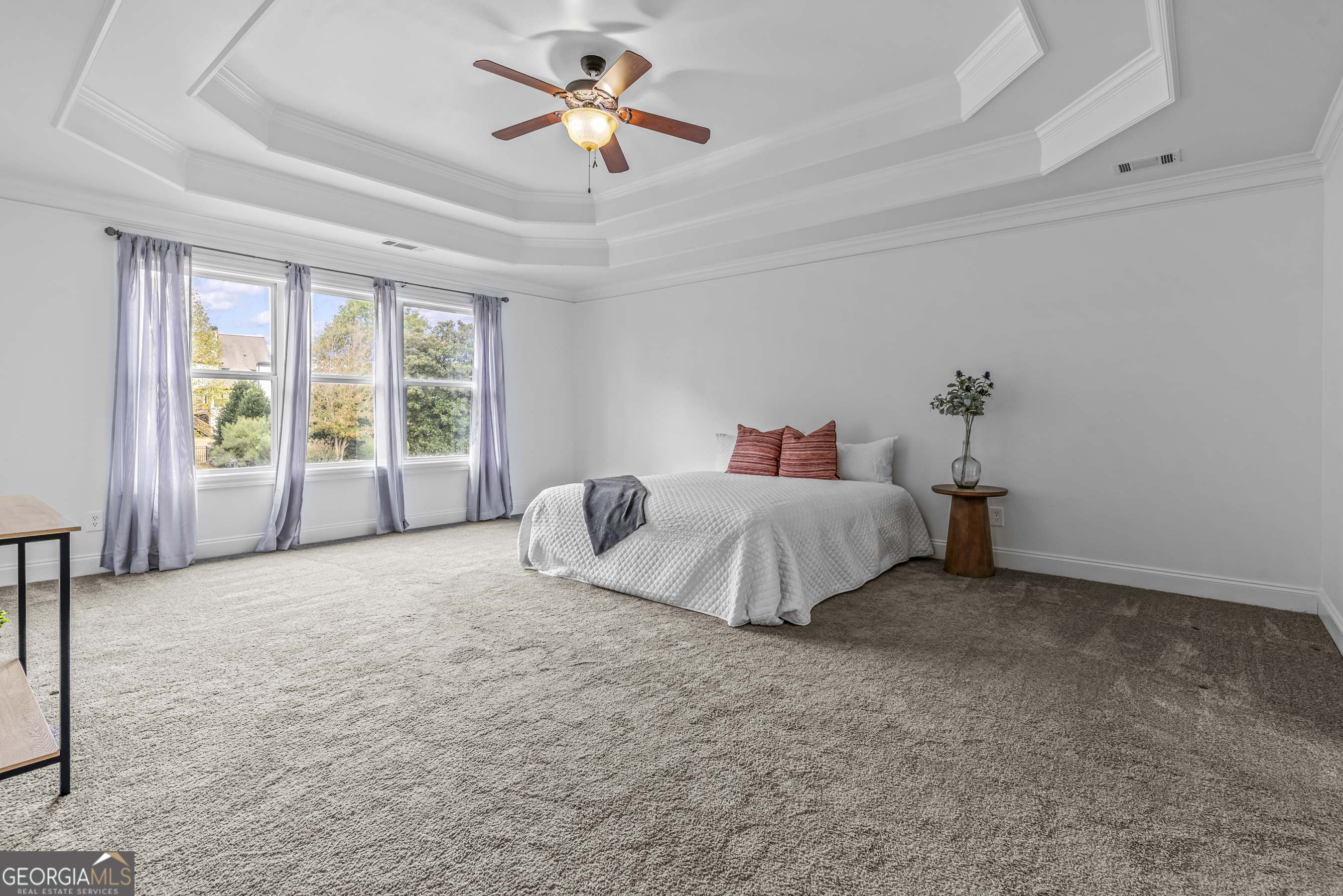 463 Delaperriere Loop Jefferson, GA 30549 - Photo 20 of 75 a spacious bedroom with a bed and a chandelier