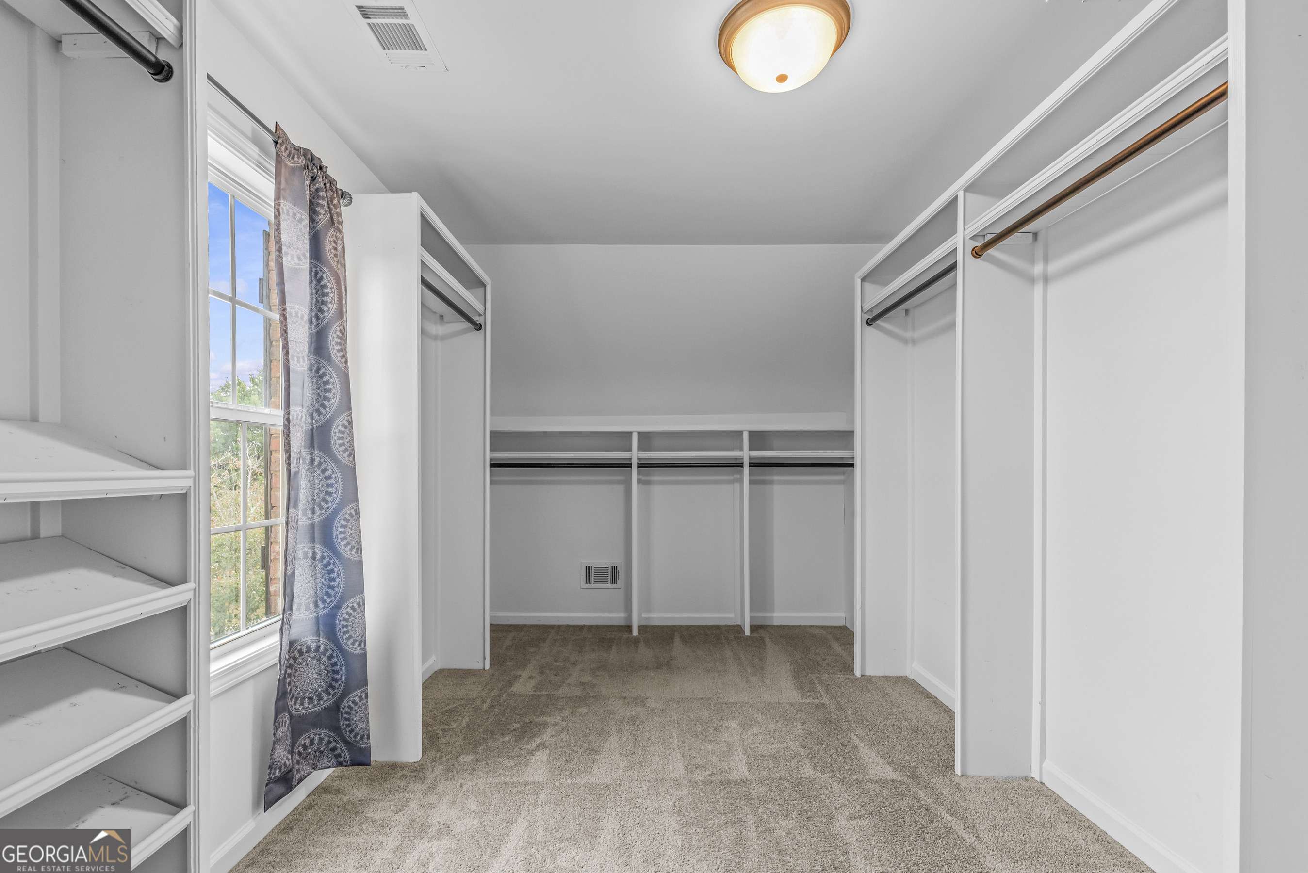 463 Delaperriere Loop Jefferson, GA 30549 - Photo 25 of 75 a view of walk in closet with empty racks