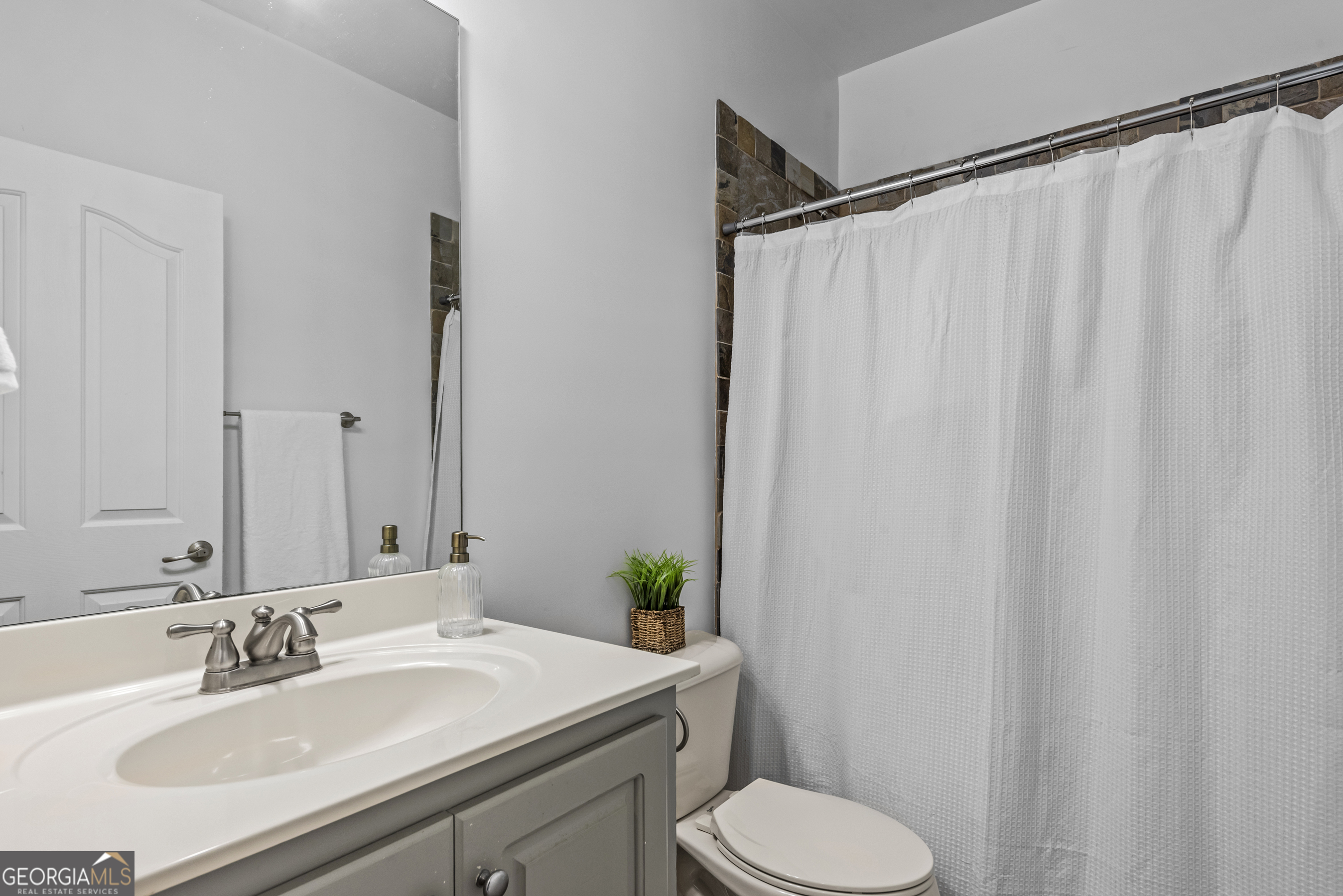 463 Delaperriere Loop Jefferson, GA 30549 - Photo 35 of 75 a bathroom with a sink and a mirror
