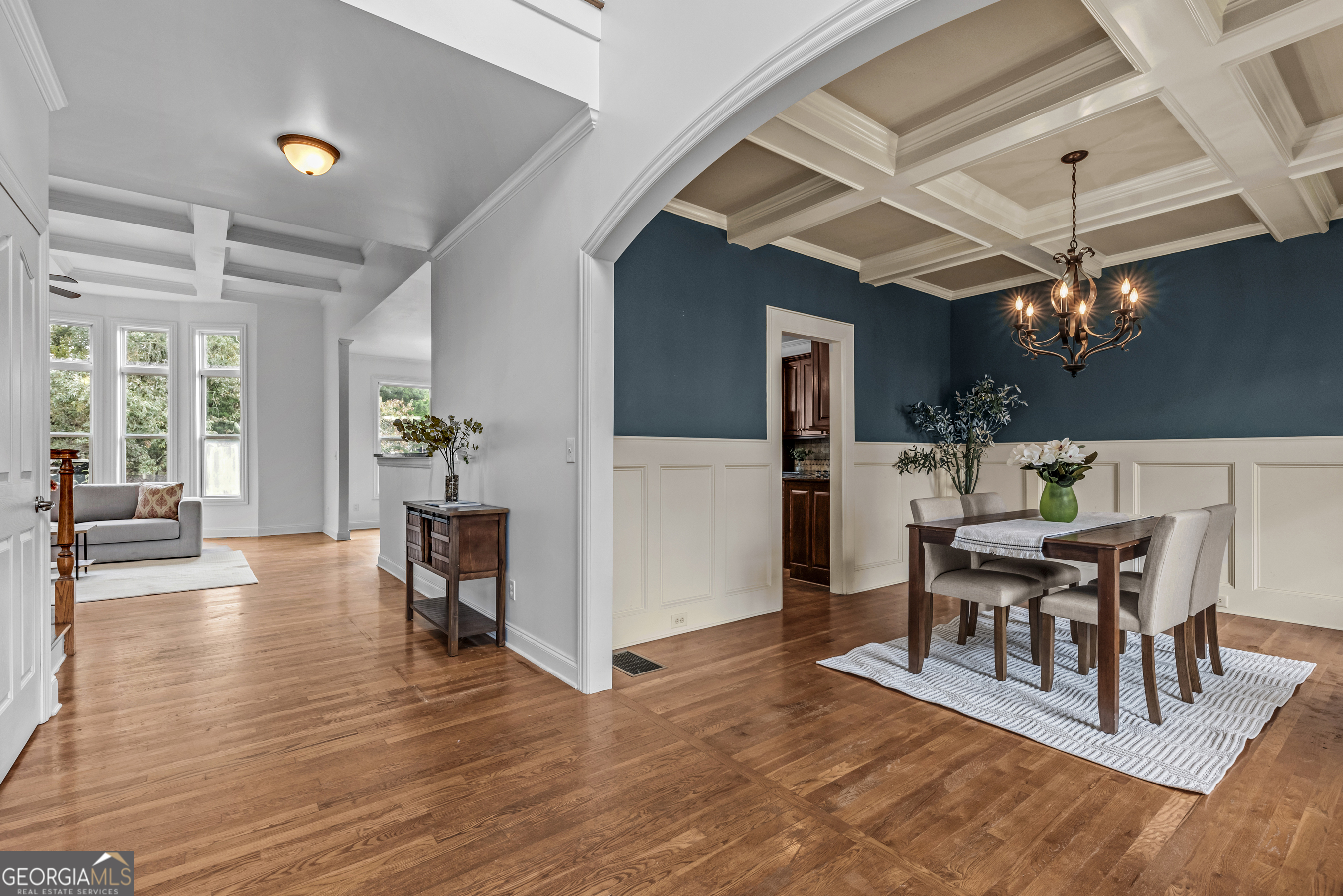 463 Delaperriere Loop Jefferson, GA 30549 - Photo 4 of 75 a dining room with wooden floor a chandelier a glass table and chairs