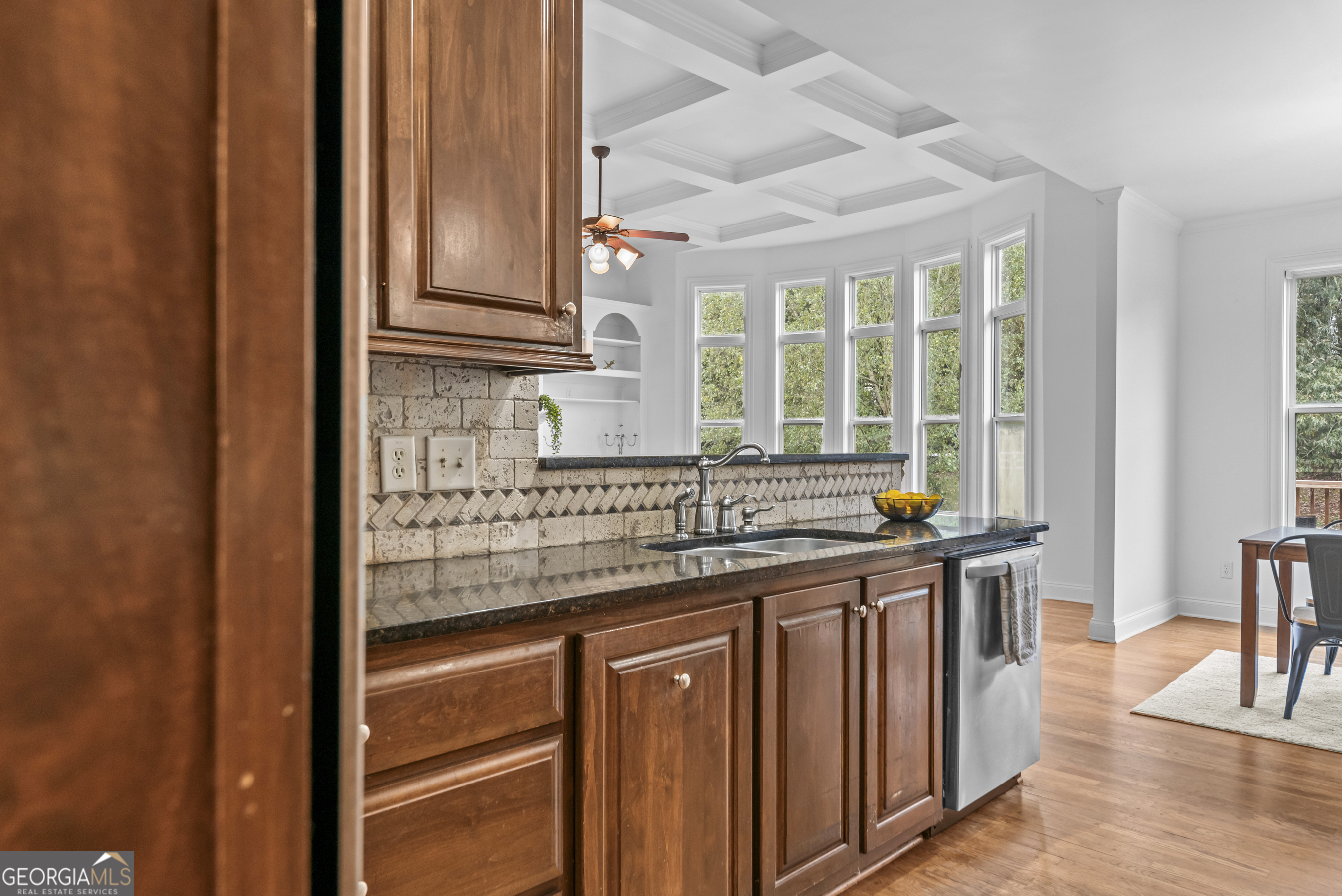 463 Delaperriere Loop Jefferson, GA 30549 - Photo 55 of 75 a kitchen with stainless steel appliances granite countertop a sink and a stove with wooden floor