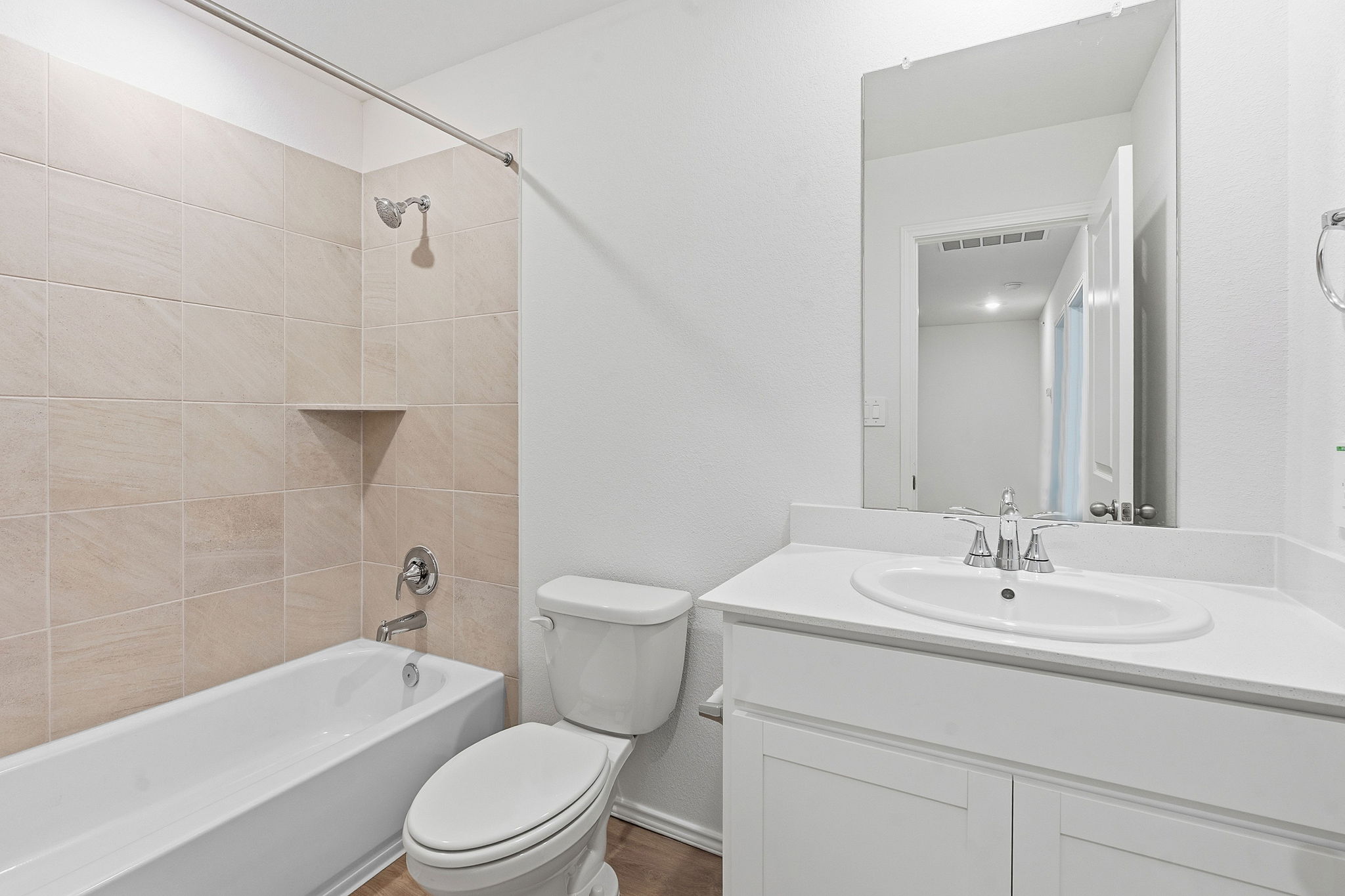 164 Cinnabar Lane, Unit 2 Kyle, TX 78640 - Photo 17 of 21 Full bathroom featuring a white vanity with an integrated sink, a rectangular mirror, and a toilet