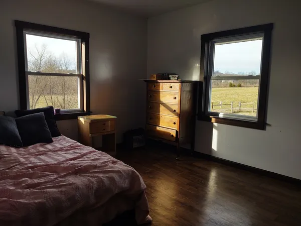 a bedroom with a bed and a window