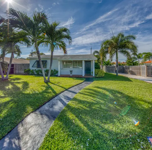 a view of a house with swimming pool and a yard
