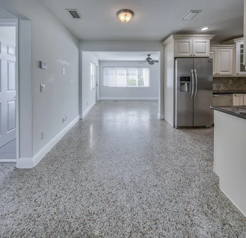 a view of a kitchen with a sink and refrigerator