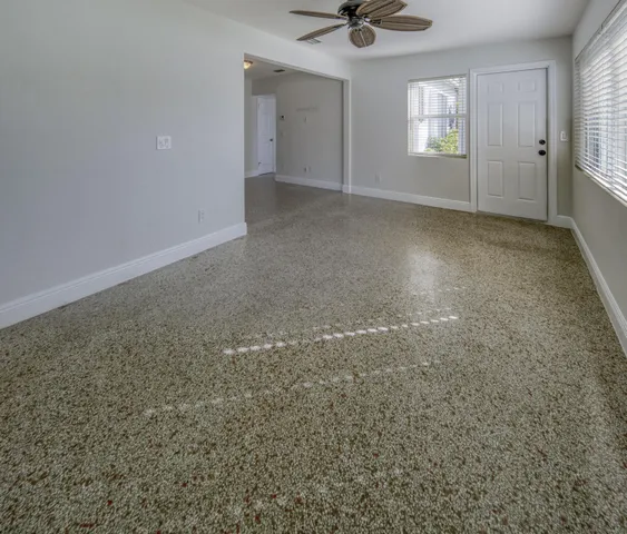 an empty room with a empty space and windows