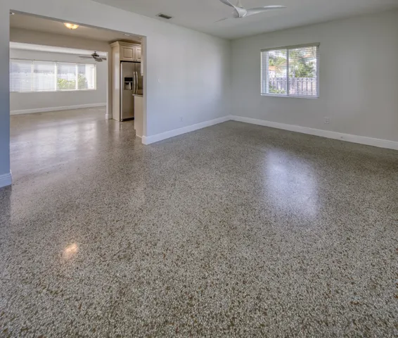 an empty room with windows and entrance