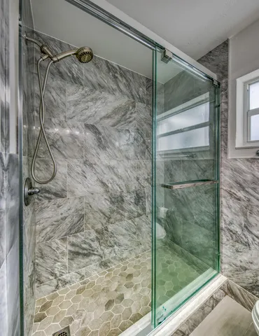 a bathroom with a glass shower door