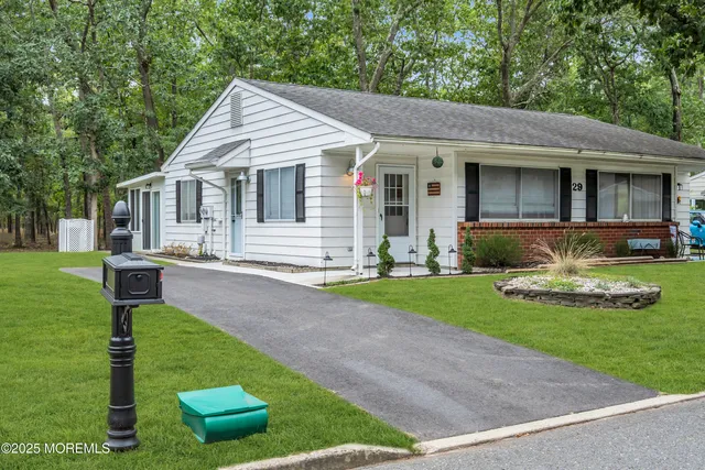 a front view of a house with garden and patio
