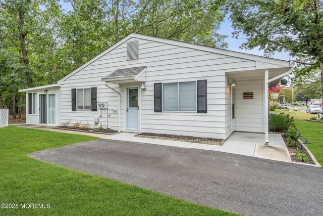 a view of a park with a tree in the grass