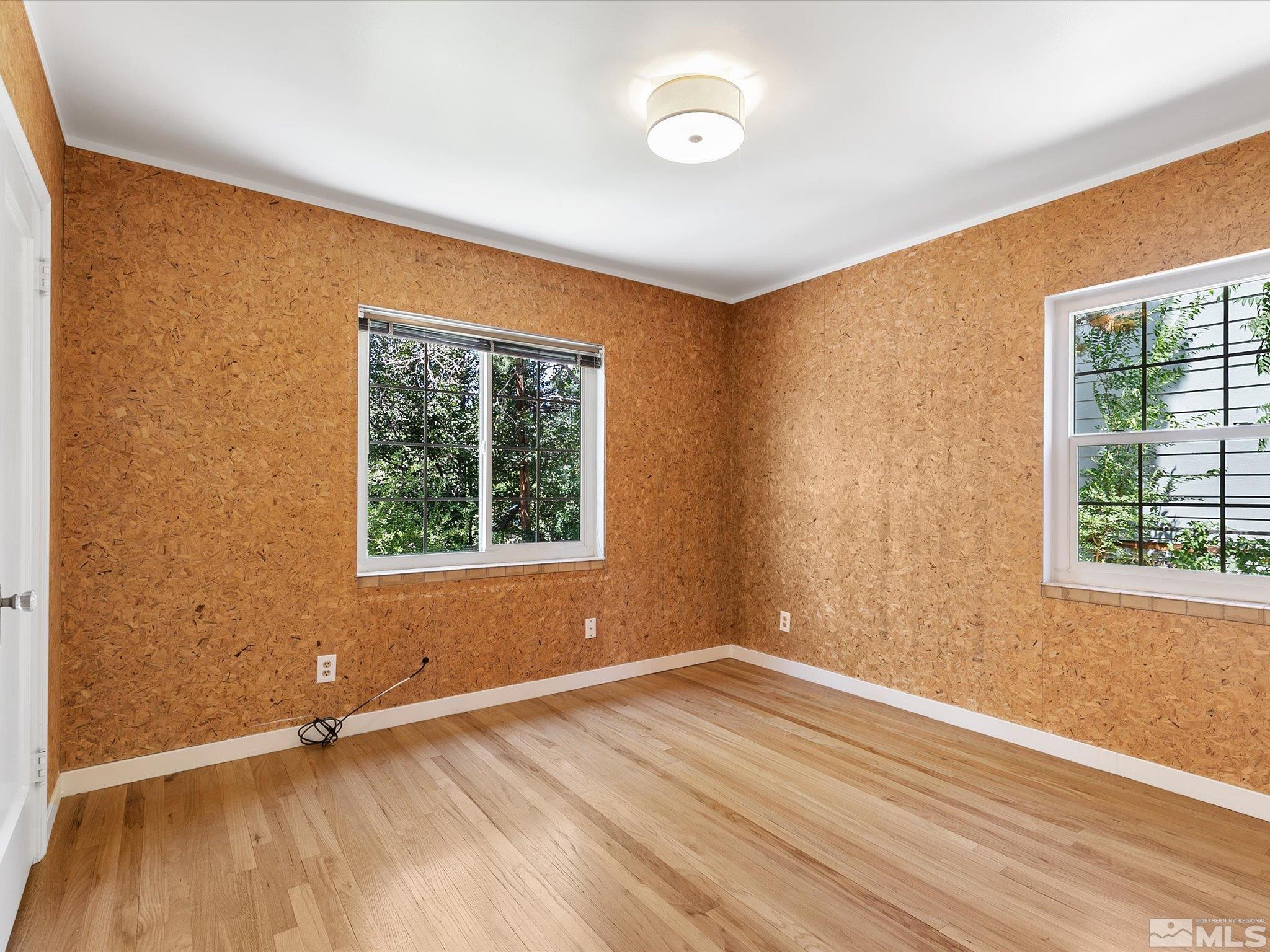 811 Washington Street Reno, NV 89503 - Photo 12 of 35 an empty room with wooden floor and windows