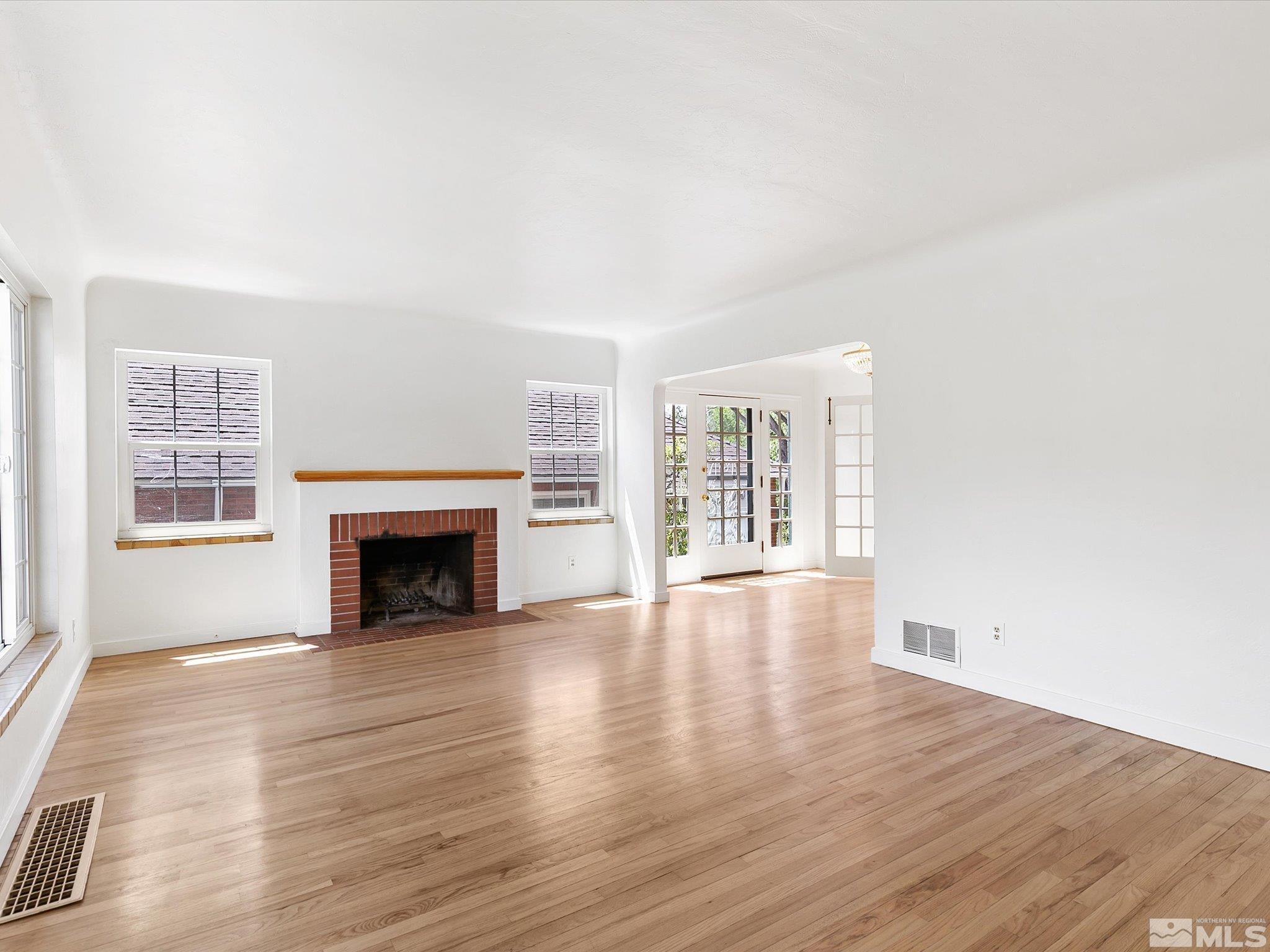 811 Washington Street Reno, NV 89503 - Photo 4 of 35 a view of an empty room with wooden floor and a window