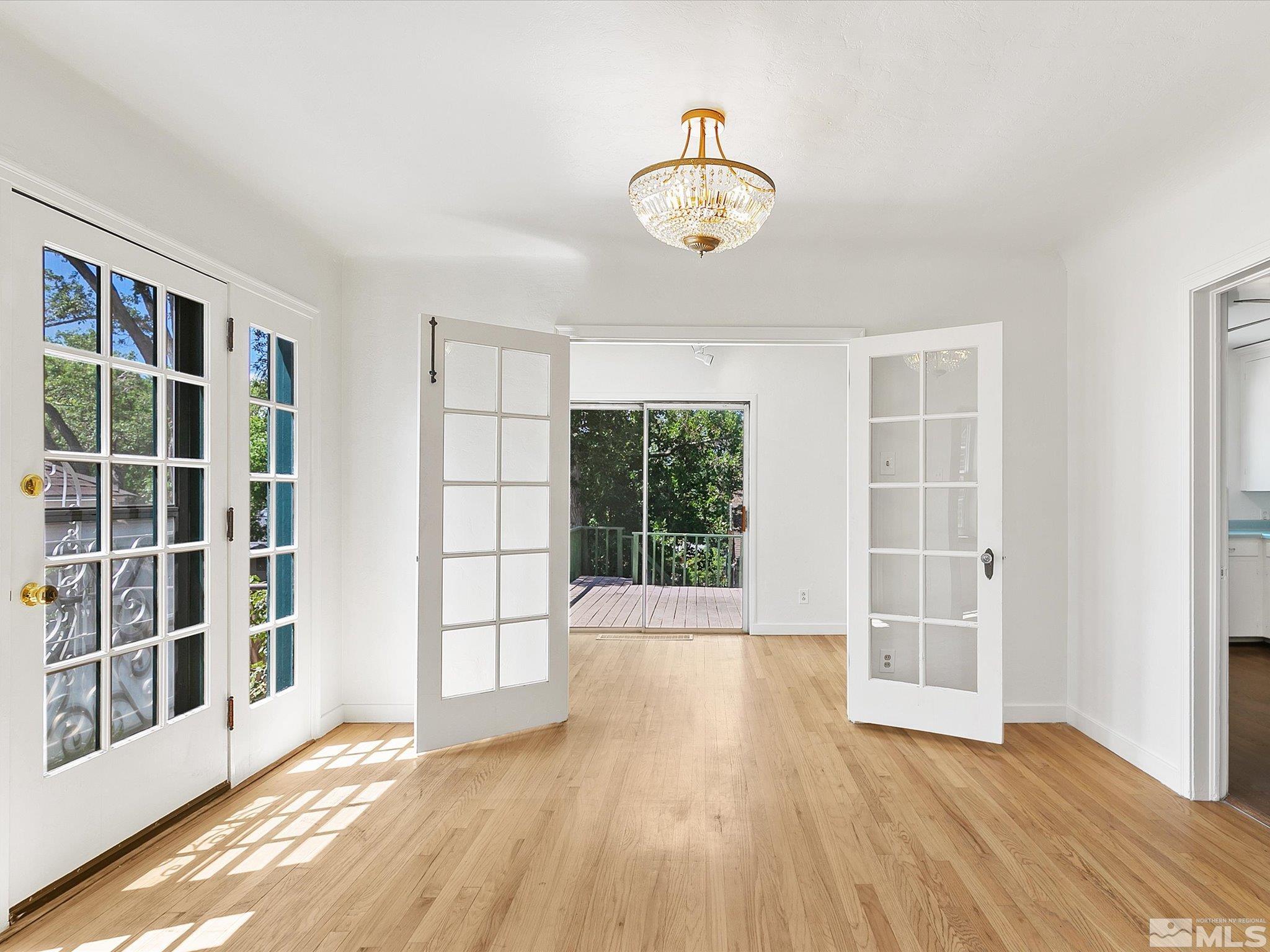 811 Washington Street Reno, NV 89503 - Photo 5 of 35 a view of an empty room with a window and wooden floor