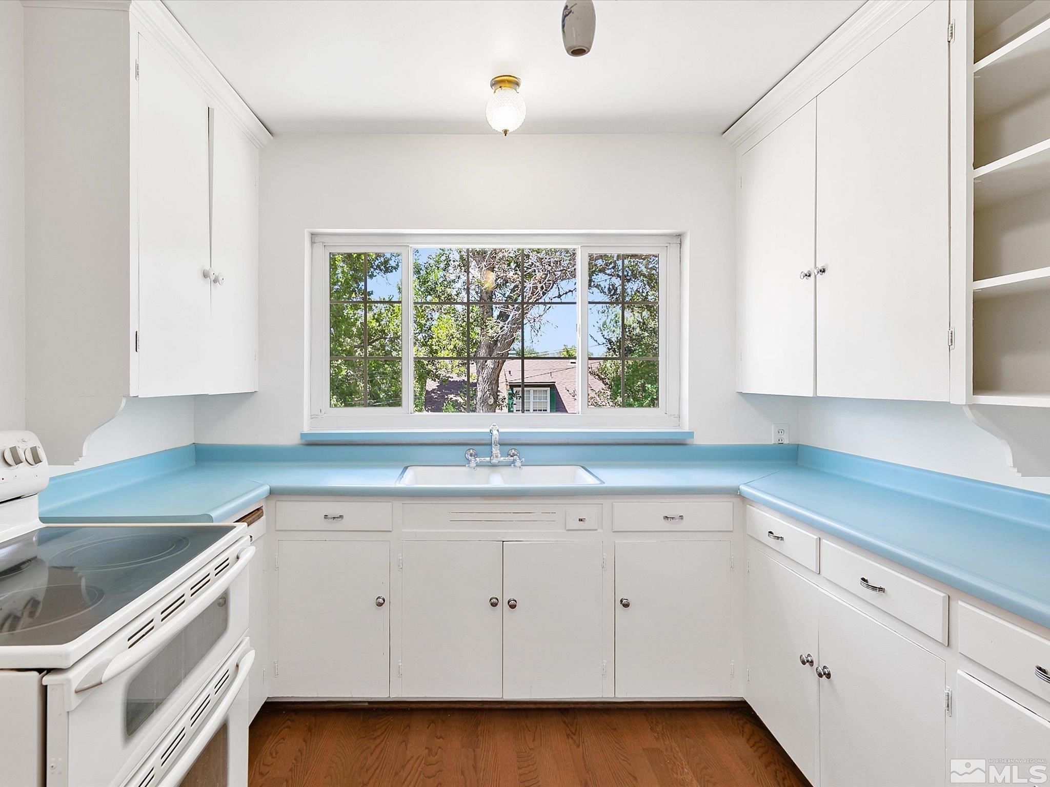 811 Washington Street Reno, NV 89503 - Photo 8 of 35 a kitchen with a sink window and cabinets