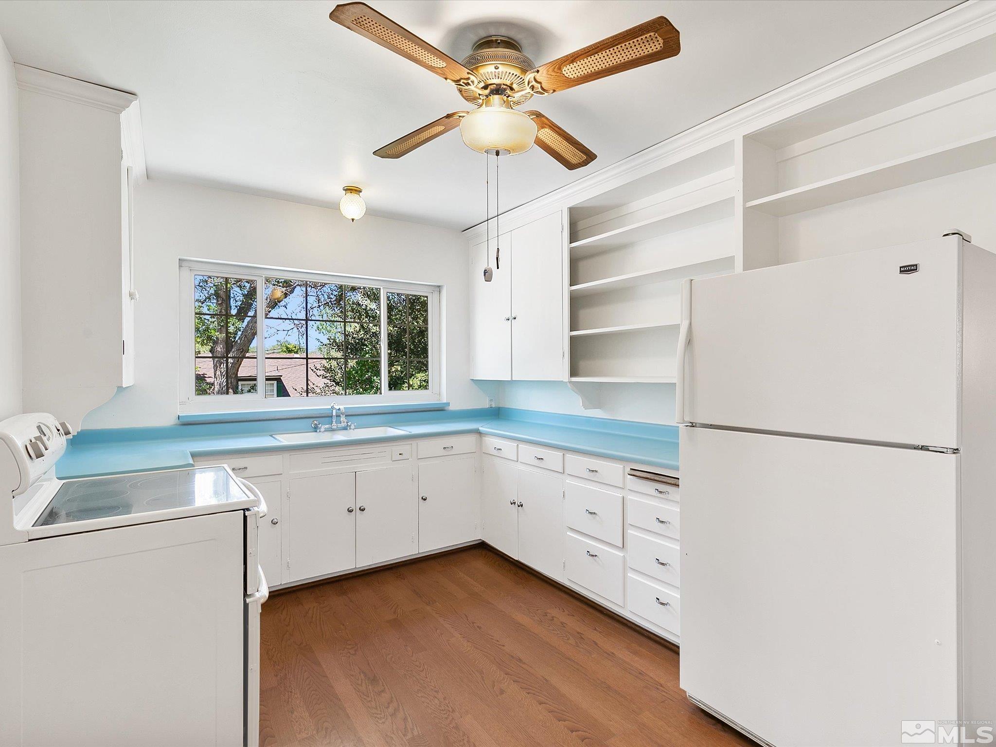 811 Washington Street Reno, NV 89503 - Photo 9 of 35 a kitchen with white cabinets and white appliances