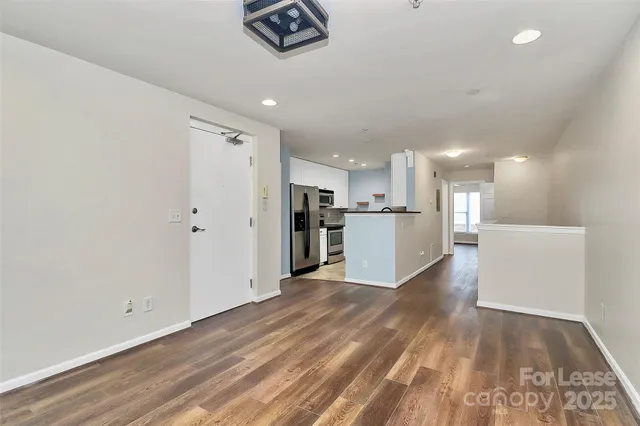 a view of kitchen appliances wooden floor and window