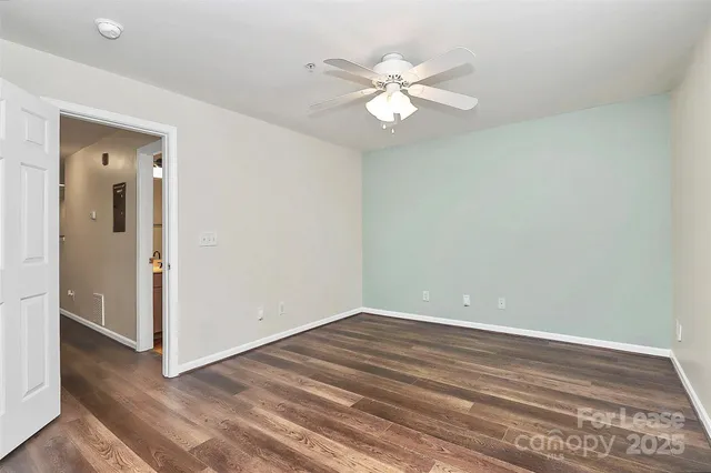 a view of a room with wooden floor
