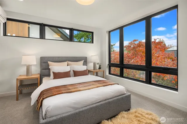 a bedroom with a large bed and a large window