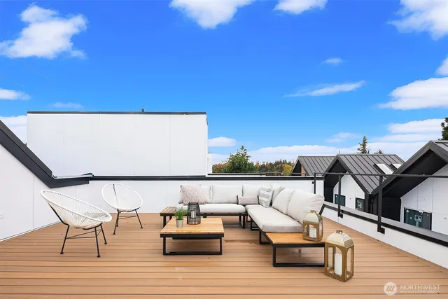 a view of couches with wooden floor and city view