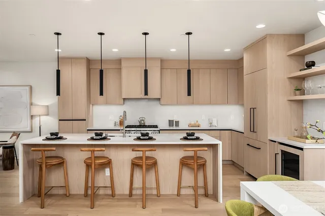 a kitchen with stainless steel appliances granite countertop a stove top oven a sink a counter top space and cabinets