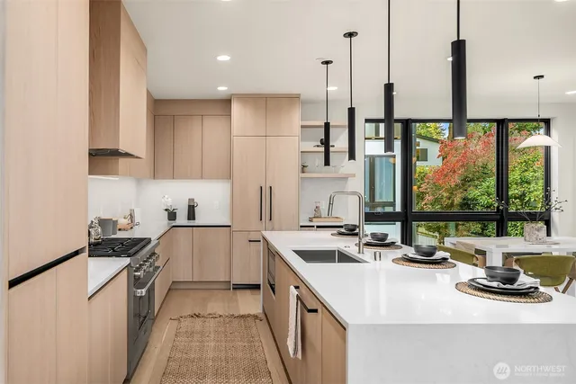 a kitchen with a sink a stove and a refrigerator