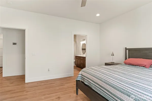 a bedroom with a bed and wooden floor