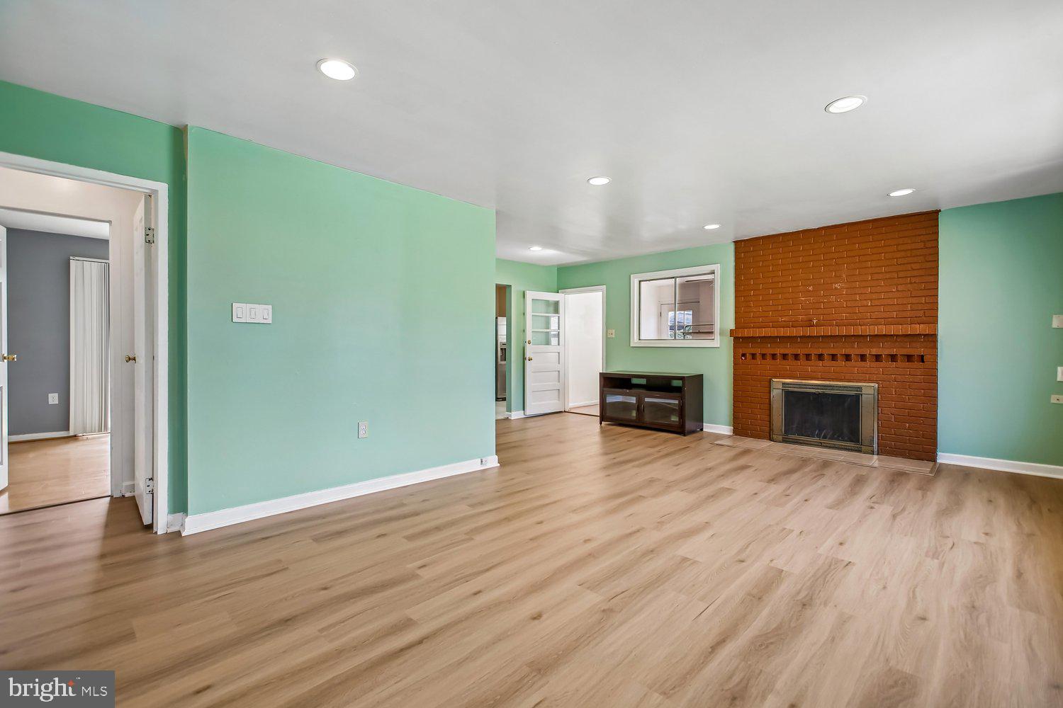 3610 Parklane Road Fairfax, VA 22030 - Photo 25 of 55 an empty room with wooden floor fireplace and cabinet