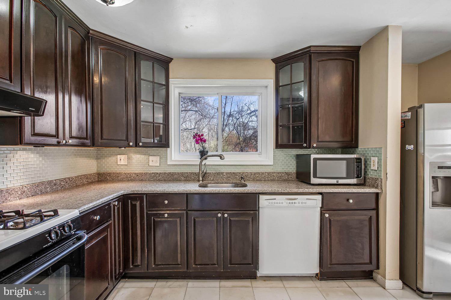 3610 Parklane Road Fairfax, VA 22030 - Photo 33 of 55 a kitchen with stainless steel appliances granite countertop a stove a sink and a microwave