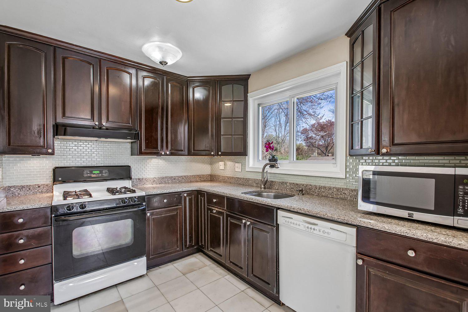 3610 Parklane Road Fairfax, VA 22030 - Photo 34 of 55 a kitchen with stainless steel appliances granite countertop a stove a sink and a microwave