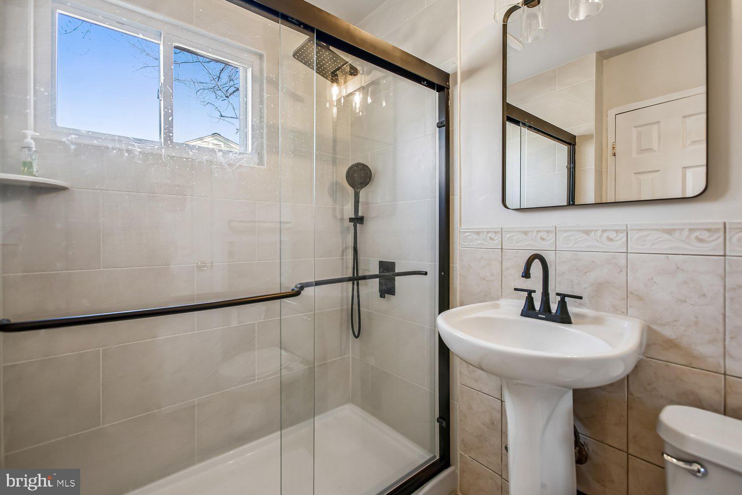 3610 Parklane Road Fairfax, VA 22030 - Photo 45 of 55 a bathroom with a sink a mirror a vanity and shower