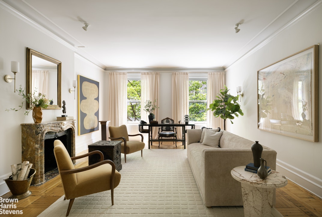 57 East 74th Street Manhattan, NY 10021 - Photo 10 of 60 a living room with furniture and a large window