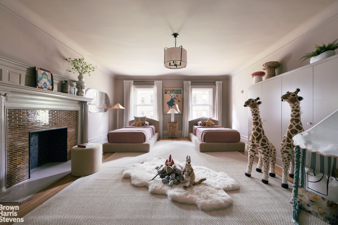 57 East 74th Street Manhattan, NY 10021 - Photo 23 of 60 a living room with furniture and a fireplace