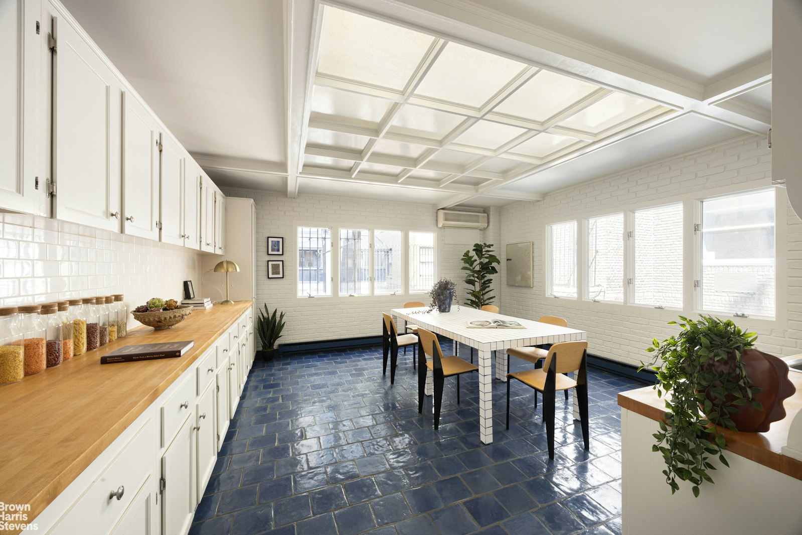 57 East 74th Street Manhattan, NY 10021 - Photo 43 of 60 a kitchen with a table chairs and a stove