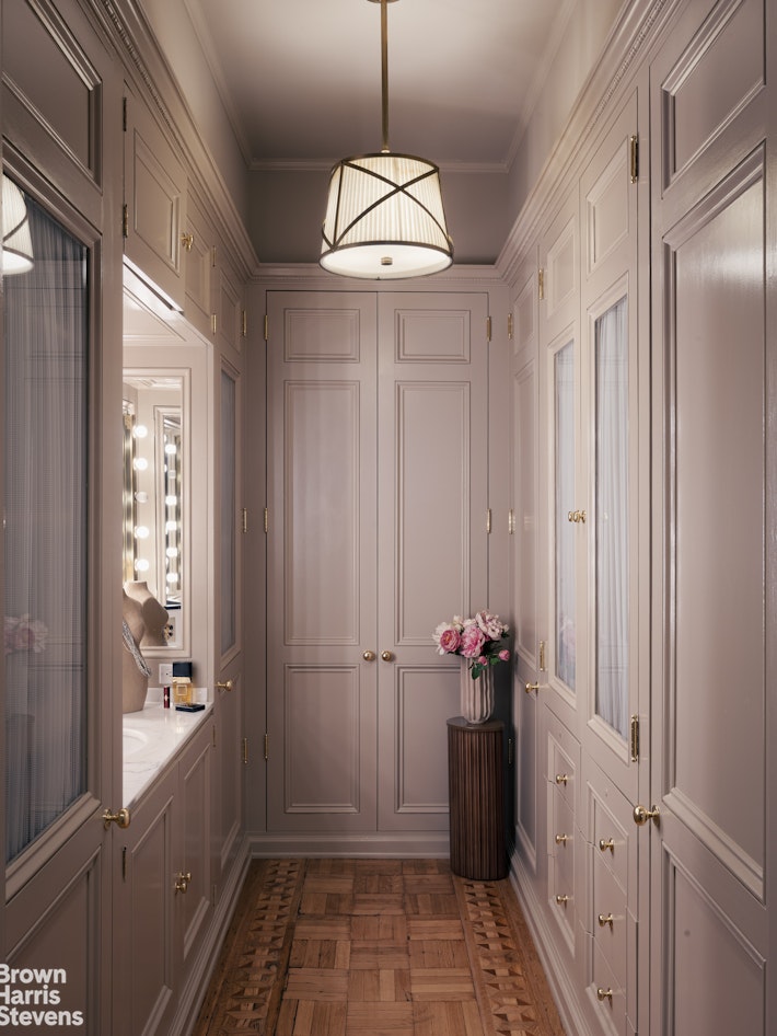 57 East 74th Street Manhattan, NY 10021 - Photo 47 of 60 a view of a hallway with wooden floor and cabinet